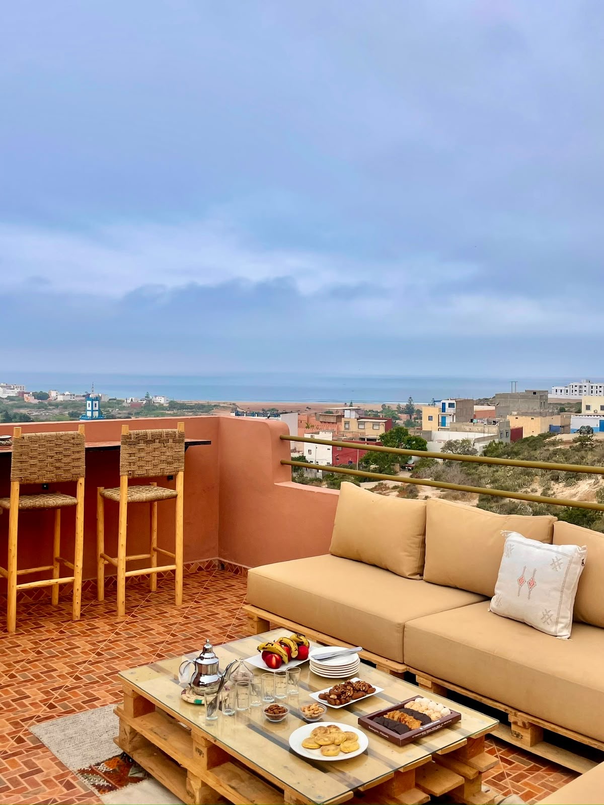 Mint tea and snacks on the Yara Lodge rooftop lounge, ocean on the horizon