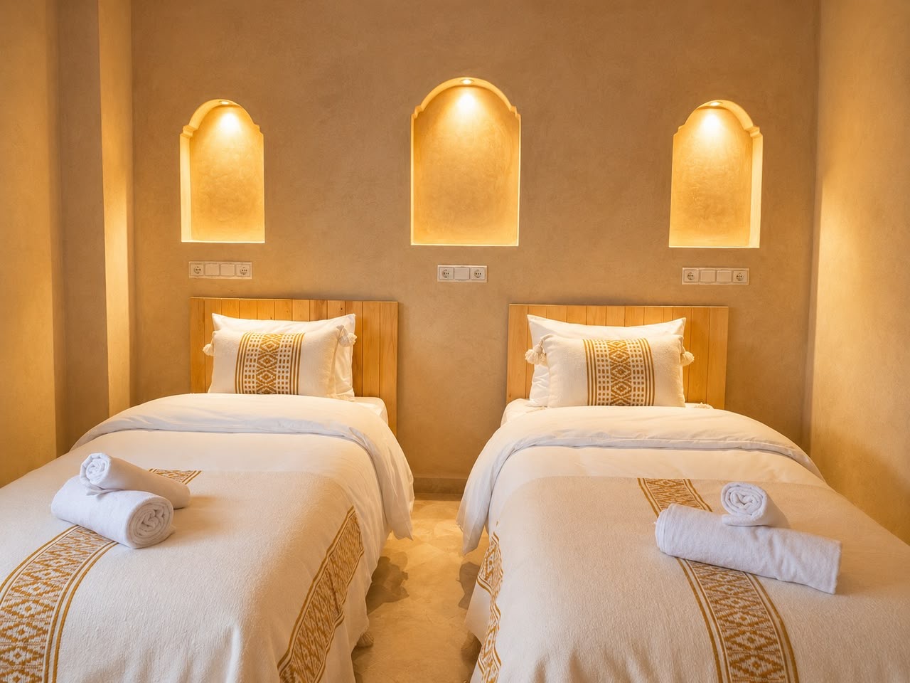 Twin room with three lit arched niches above the beds